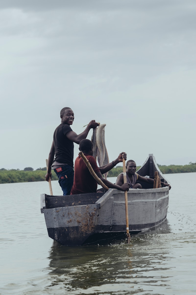 Africa Fisheries and African coastal fishermen and women practicing sustainable fishing on traditional boats